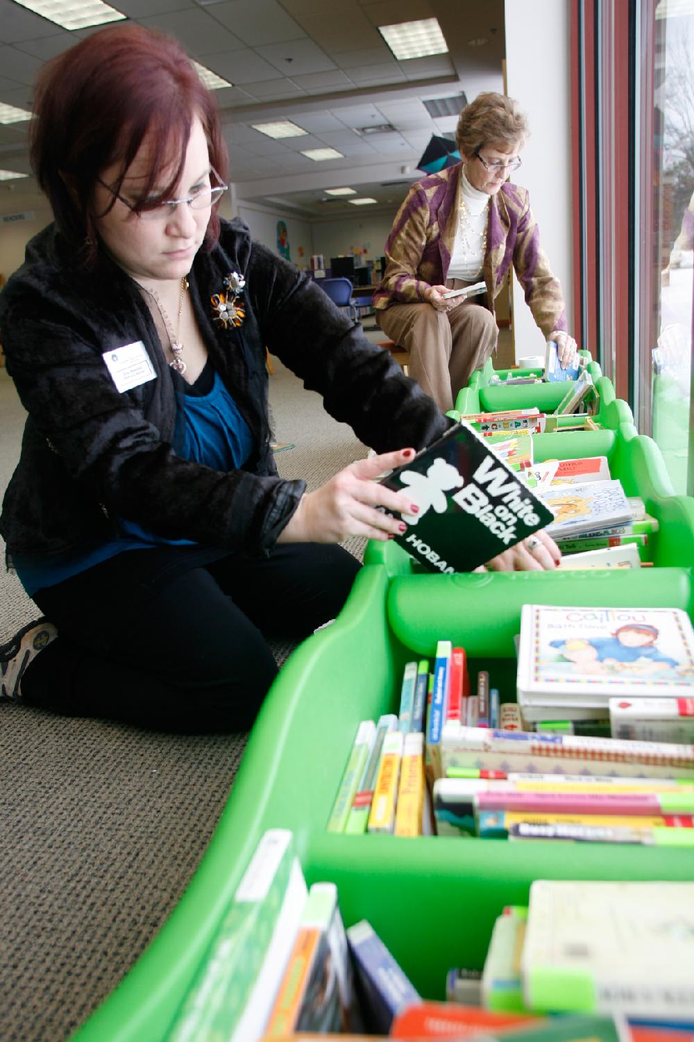 Arkansas Democrat-Gazette/RYAN MCGEENEY --02-07-11--
Children's Assistant Librarians Erin Renollet, left, and Judy Lewis organize children's books Monday morning in the Springdale Public Library. The library received several hundred returns Monday morning after a week of school closings and the library itself being closed Saturday and Sunday due to inclement weather. Warmer temperatures over the weekend caused accumulated snow and ice to melt, allowing many area residents to return to school and work.