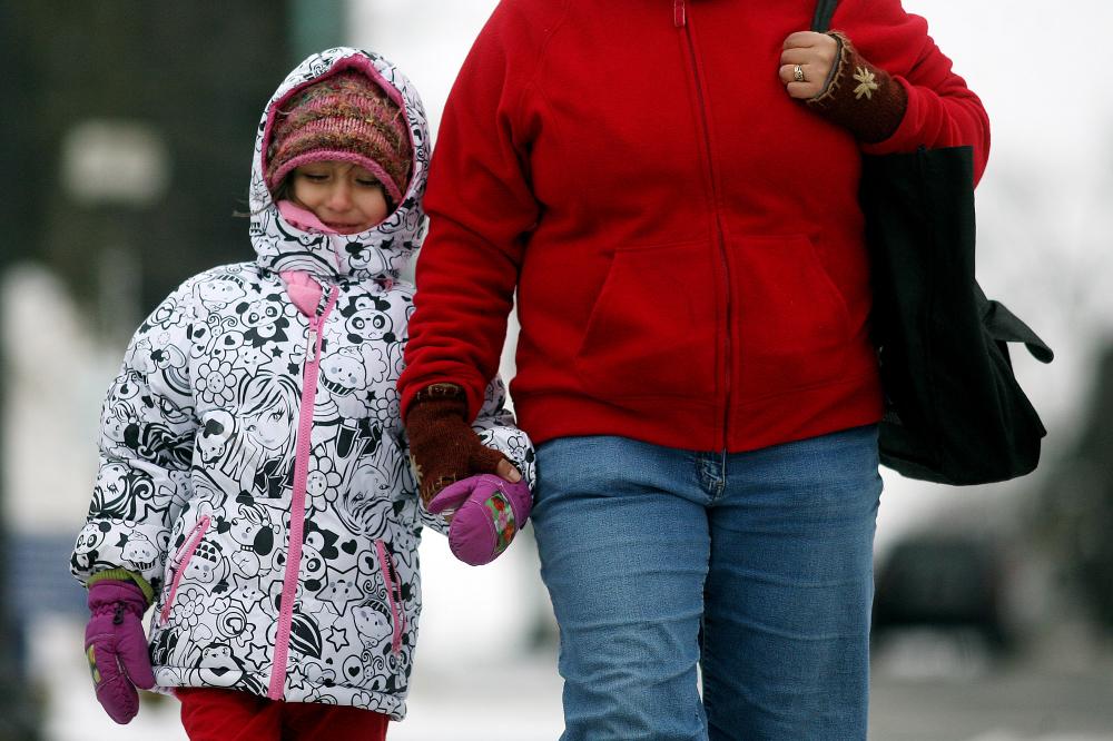 Arkansas Democrat-Gazette/WILLIAM MOORE
Bundled up against the weather, Mira Huff, 5, holds the hand of her mom Rachel Huff of Fayetteville back to work at World Treasures on North Block Avenue from the library Monday, February 7, 2010 in Fayetteville.  Northwest Arkansas residents can expect more winter weather this week.