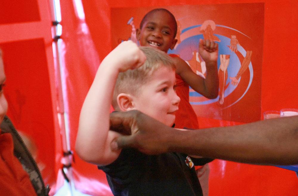 Arkansas Democrat-Gazette/RICK MCFARLAND--02/07/11-- C.J. Malone (front) and Keyshawn Golden, both kindergarten students, show off their muscles at the nutrition station for Body Walk, a 30 ft by 36 ft walk-through exhibit that visited Dupree Elementary School in Jacksonville Monday. The exhibit is operated by the University of Arkansas Division of Agriculture Cooperative Extension Service.