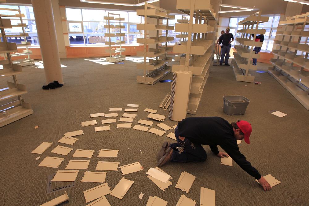 Arkansas Democrat-Gazette/BENJAMIN KRAIN --1/27/11--
Greg Clements helps other Central Arkansas Library System workers put together new book shelves at the Main Library branch in downtown Little Rock. The library is moving 200000 books from the first floor to the newly-remodeled 5th floor.