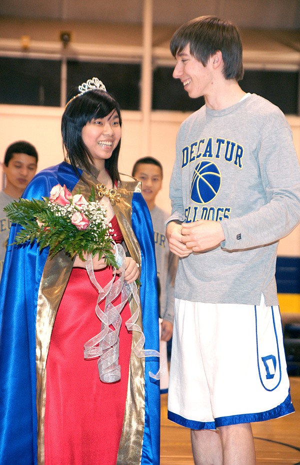 Decatur High School Colors Day Queen Chai (Shelly) I-Hsuan smiles alongside captain Mitchell Nelson.