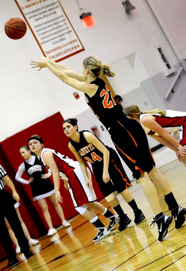 Kaitlyn Britton pushes the ball toward a free throw point while Amanda White waits for a rebound. The Gravette Lady Lions took the 54-23 victory from the Pea Ridge girls.