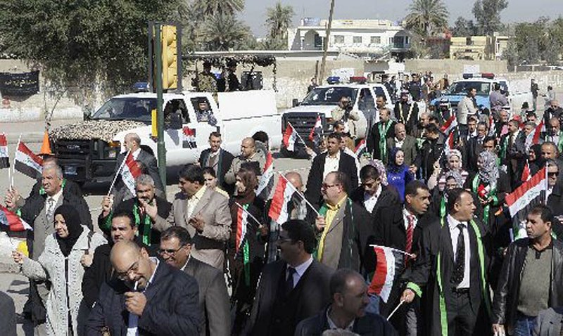  Protesting lawyers take to the streets, waving Iraqi flags Thursday in Baghdad. 