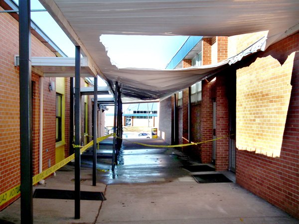 Heavy snow last week caused the awning over the walkway between the Decatur High School administration building and cafeteria to sag dangerously. Part of the awning was cut away so the snow could melt away in a controlled manner without doing any more damage. Yellow caution tape kept students away when school resumed on Monday.

