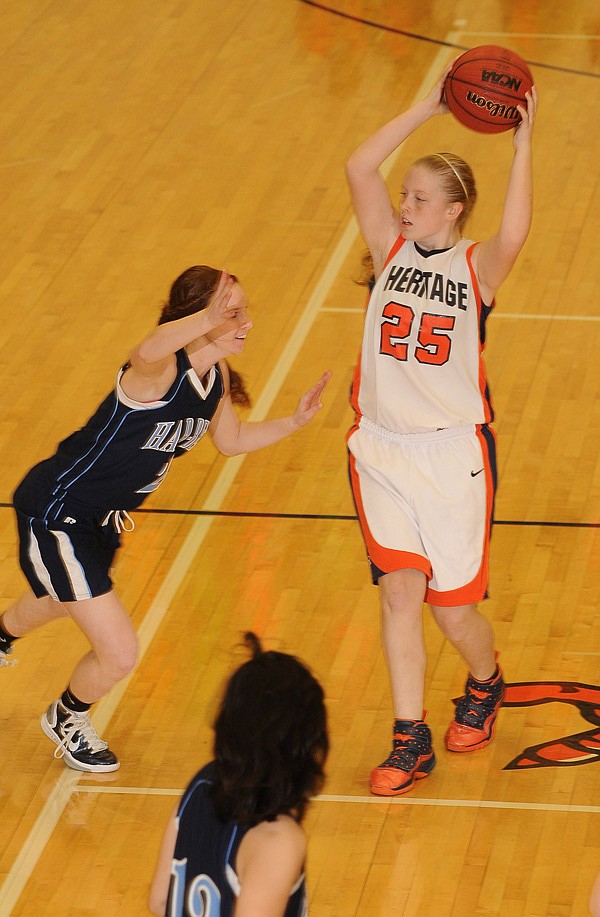  Rogers Heritage’s Lacey Murray looks for an opening against Springdale Har-Ber on Jan. 28 in War Eagle Arena in Rogers.
