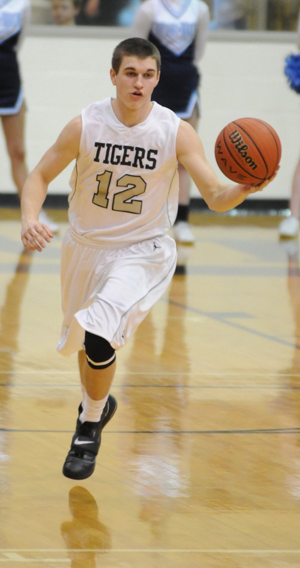  Bentonville’s Austin Heard, a sophomore, handles the ball during a recent game. Heard has been a fixture as point guard in the Tigers’ starting lineup.
