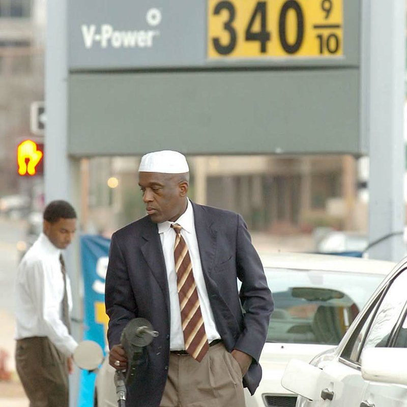 Muhammas Rahman fills his gas tank Thursday at the Shell station at Broadway and Eighth Street in Little Rock. 