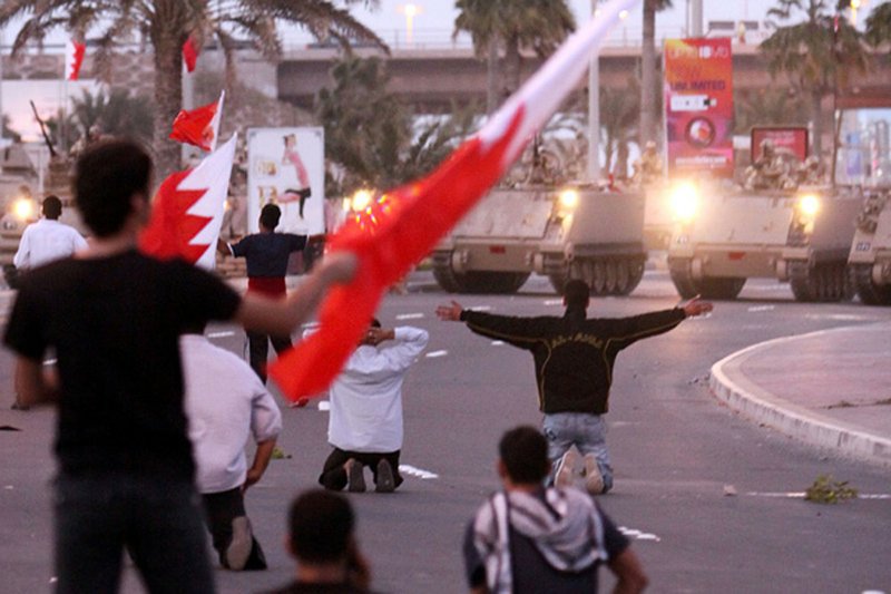 Bahraini protesters face off against army tanks Friday near Pearl Square in Manama.

