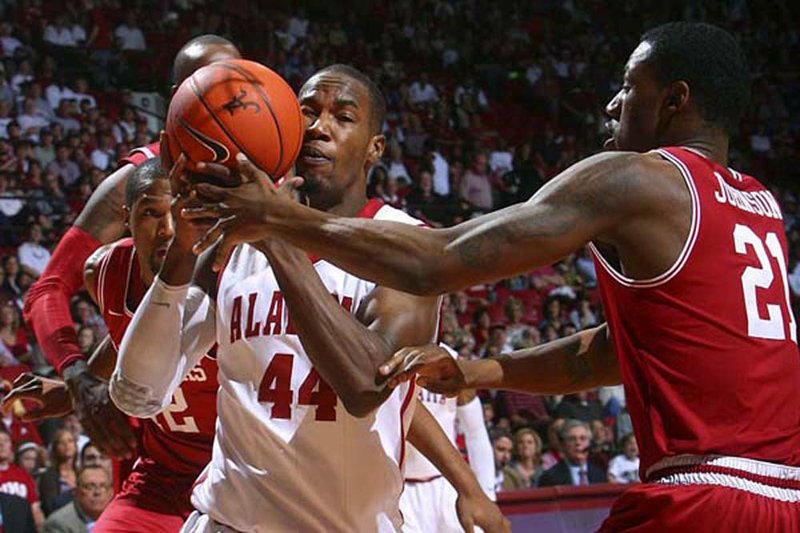 Arkansas forward Delvon Johnson (21) fouls Alabama’s Chris Hines (44) in the Crimson Tide’s 69-56 victory Saturday at Coleman Coliseum in Tuscaloosa, Ala.

