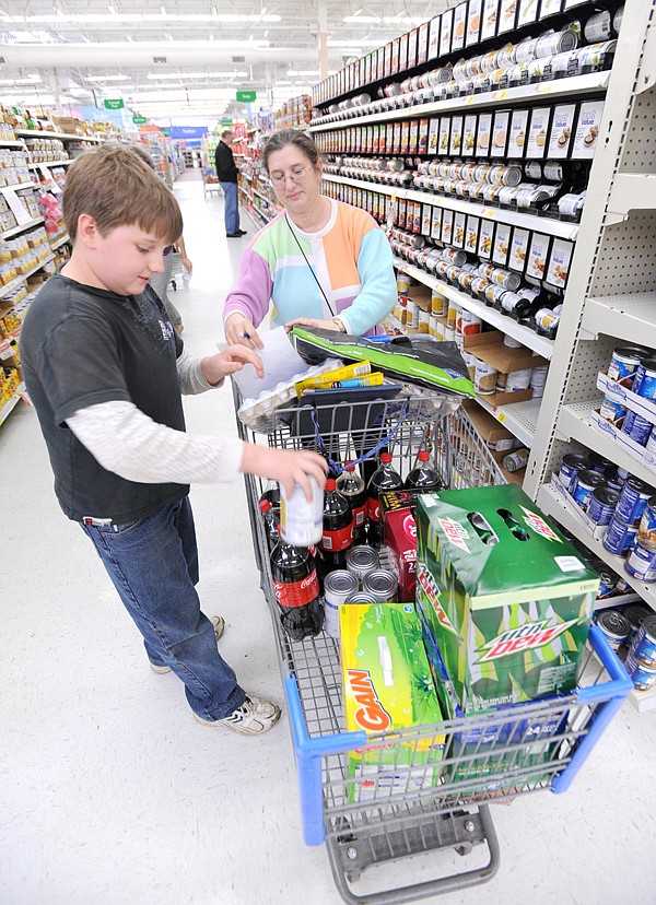 Janice Jorgenson of Winslow and her son, Gauge, 11, shop Tuesday for supplies for the Sky-Vue Lodge which the Jorgensons operate.
