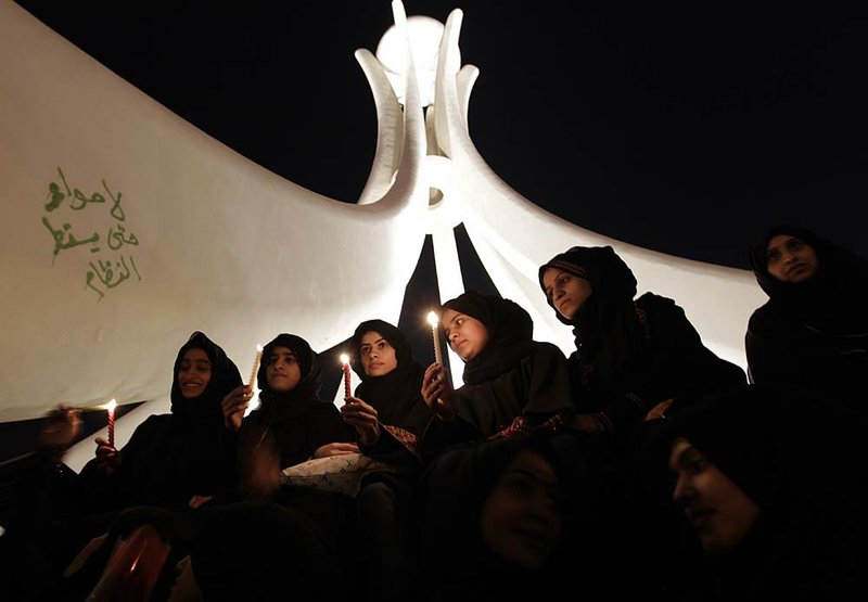 Protesters hold a vigil Saturday in Pearl Square in Manama, Bahrain, after military and police personnel were ordered out and advocates flooded back in.

