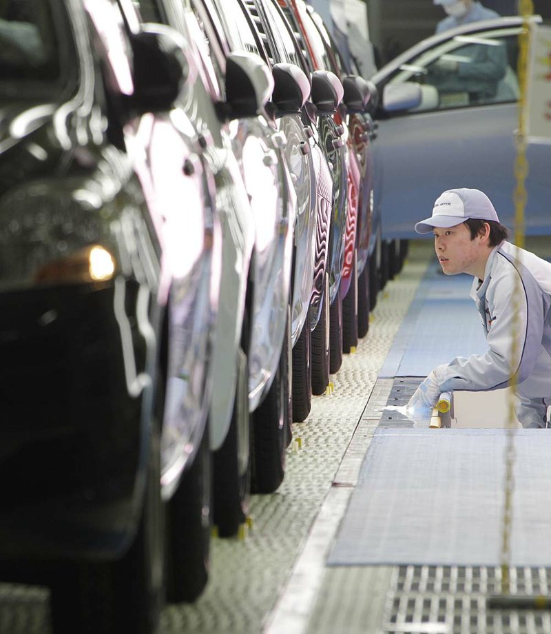 A worker gives the final check on Yaris compact sedans, set for export to North America, on a newly opened assembly line at a plant of Toyota Motor Co.'s group company Central Motor Co. in Ohira in Miyagi Prefecture, northern Japan, Wednesday, Feb. 16, 2011. Toyota celebrated the opening of the auto plant in a forsaken rural area of Japan, which promises to grow into a new production point for the world's largest automaker. 