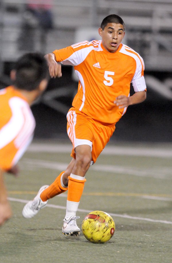 The War Eagles’ Phillip Amaya moves the ball downfield against the Mounites at Heritage High School in Rogers, April 16.