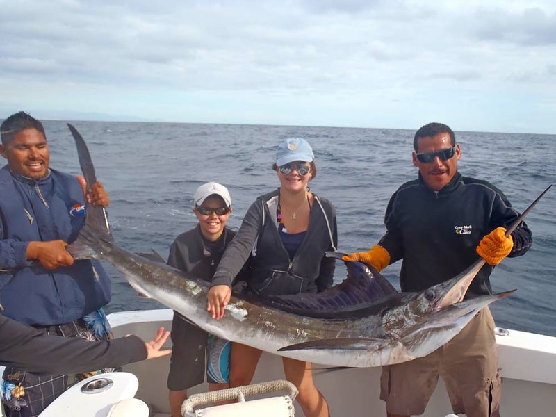 Emily Franks (second from right) caught this 130-pound striped marlin Dec. 30 in the Pacific Ocean near Camo San Lucas, Mexico, after her friend Smith Ney (second from left) dedicated the first fish of the day to her. Ney caught a large mahi-mahi later that day.

