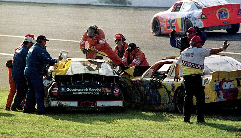 Rescue personnel work to free Dale Earnhardt Sr. from his No. 3 car after he collided with Ken Schrader on the final lap in the 2001 Daytona 500. Earnhardt was killed in the crash, prompting NASCAR to institute several safety changes.

