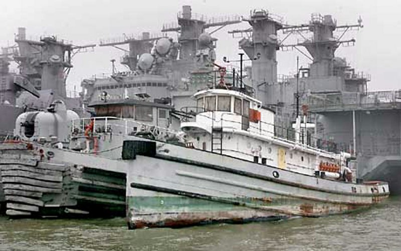 The US Navy tugboat USS Hoga (foreground, right)is the last operational vessel that survived Japan's WWII attack on the navy base at Pearl Harbor. 