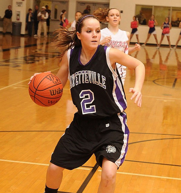 Fayetteville guard Clair Childers drives the lane against Bentonville at Tiger Arena in Bentonville on Friday.