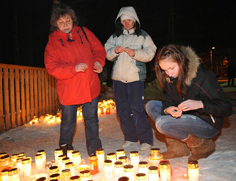 People light candles in memory of children who died Sunday in a fire at an orphanage for disabled children in Haapsalu, Estonia.

