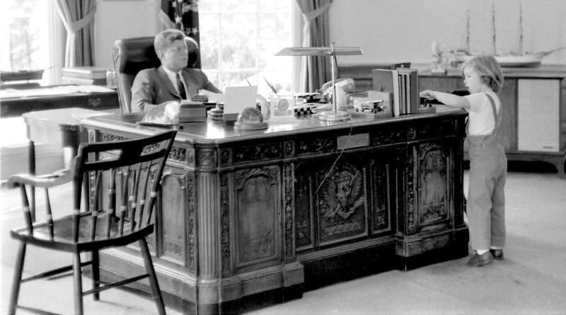 This May 16, 1962, photograph released by the John F. Kennedy Presidential Library and Museum in Boston shows President John F. Kennedy behind his desk while visited by his daughter Caroline in the Oval Office at the White House in Washington. On Monday, Feb. 21, 2011, Caroline Kennedy unveiled a new feature at the museum where anyone can use the Internet to “sit” at the virtual desk to learn more about her father's life and administration. 
