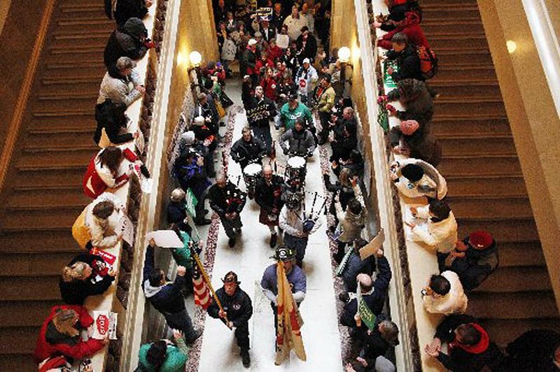  Firefighters playing bagpipes march inside the Wisconsin state Capitol on Monday. 