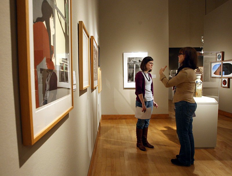 Louise Palermo (right), curator of education at the Arkansas Arts Center, gives tips on improving discussion during tours to docent Courtney Bufford. 