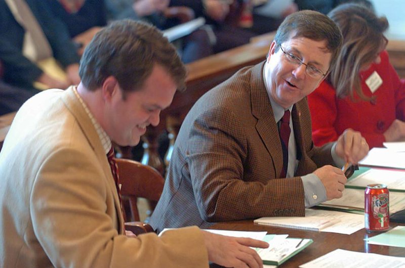 State Sen. Larry Teague (right), D-Nashville, jokes Monday with the vice chairman of the Senate Committee on Revenue and Taxation, state Sen. Michael Lamoureux, R-Russellville, after Teague’s bill, Senate Bill 276, which decreases the sales tax of food, passed through committee. The bill now goes to the Senate chamber for a vote. 