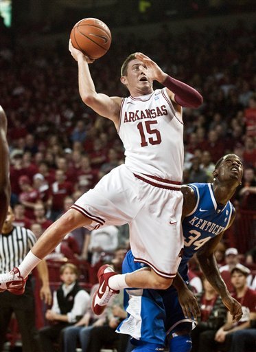 Arkansas' Rotnei Clarke (15) takes a shot as Kentucky's DeAndre Liggins (34) defends during the first half of an NCAA college basketball game in Fayetteville, Ark., Wednesday, Feb. 23, 2011. (AP Photo/April L. Brown)