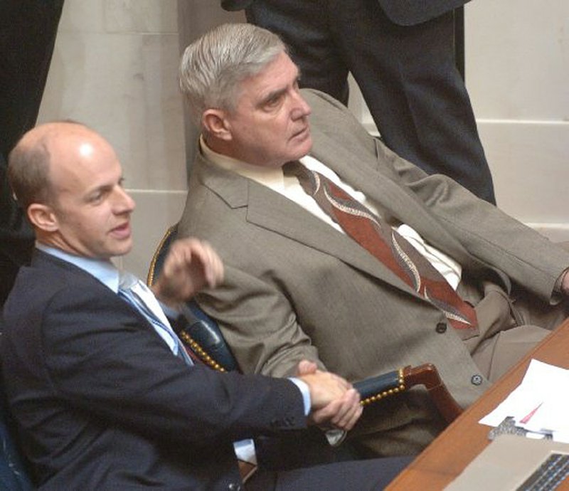  State Sen. Jake Files (left) on Tuesday congratulates state Sen. Bill Sample after Sample’s bill to give a sales-tax break to energy manufacturers was passed by the Senate. 