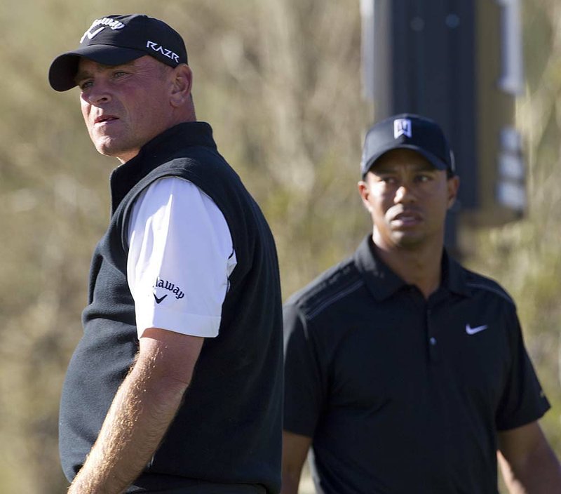 Thomas Bjorn (left) of Denmark needed an extra hole, and a bad tee shot by Tiger Woods, to eliminate Woods in the first round of the Match Play Championship. 