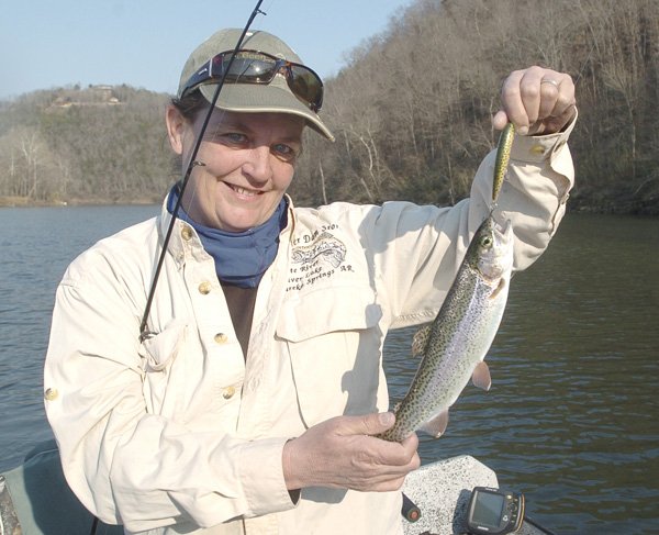 Lisa Mullins, a fishing guide from Eureka Springs, shows a rainbow trout she caught from the White River below Beaver Dam last winter. The trout management plan for the tailwater will be reviewed at a meeting on Tuesday.