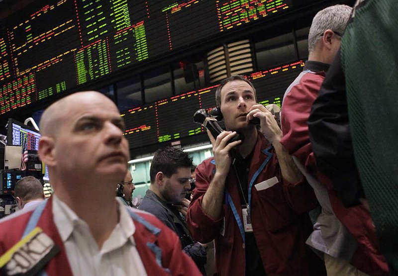 Traders work Wednesday in the crude oil options pit at the New York Mercantile Exchange as prices rose. 