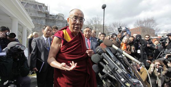 The Dalai Lama is swarmed by a crowd of reporters in this Associated Press file photo. The Dalai Lama will appear in Fayetteville on May 11.