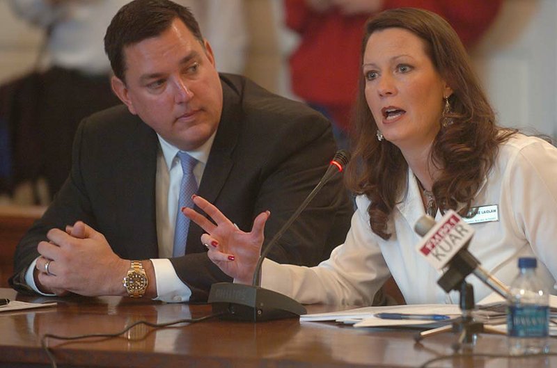 Bradley Davis of construction firm VCC listens Thursday as Anne Laidlaw of the Arkansas Building Authority addresses the possibility that illegal aliens were hired for state building work. 