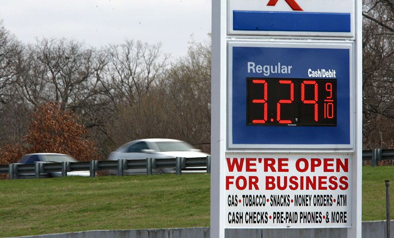 Interstate 30 traffic zooms past a service station on Roosevelt Road that had one of Little Rock’s highest prices for regular gasoline Friday. 