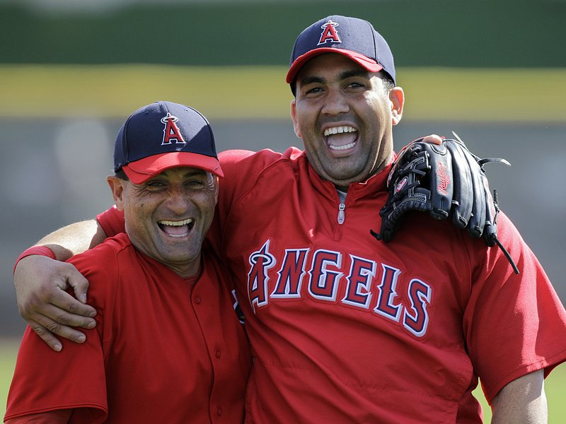 Los Angeles Angels first baseman Kendry Morales (right), joking with the team’s third base coach Dino Ebel, is on track to play on opening day after breaking his leg last season. 