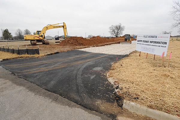 WALMART EXPRESS A sign marks the construction entrance Friday at the site of a planned Walmart Express on Industrial Park Road near the western border of Prairie Grove. The 14,869-square-foot building is being built by C.R. Crawford Construction in Fayetteville.