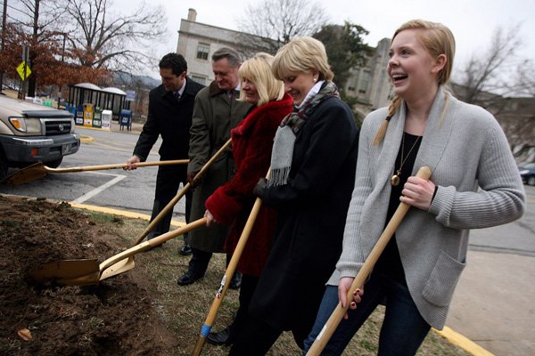 University of Arkansas Pi Beta Phi President Elizabeth Milburn (right) shovels dirt during a groundbreaking Friday for Centennial Gate, a decorative entryway planned off Maple Street near Old Main on the Fayetteville campus. Also pictured are (left of Milburn) Pi Beta Phi steering committee members Patty Pyle and Marilynn Porter, UA Chancellor G. David Gearhart and UA Director of Development Mark Power.