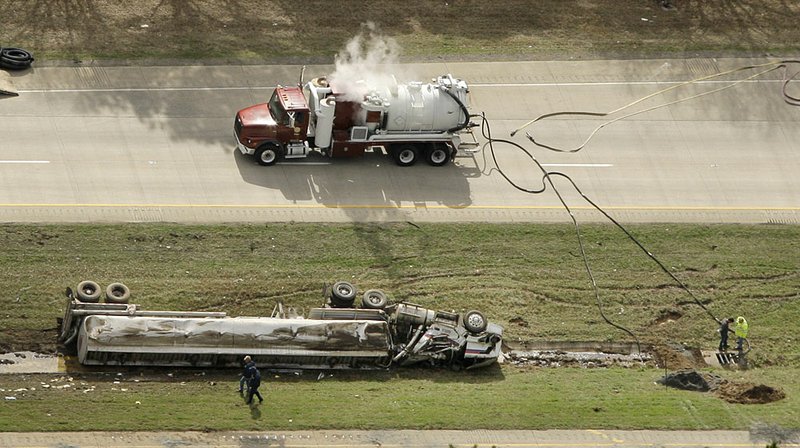 Crews clean up along Interstate 30 near Benton after a tanker accident Friday.

