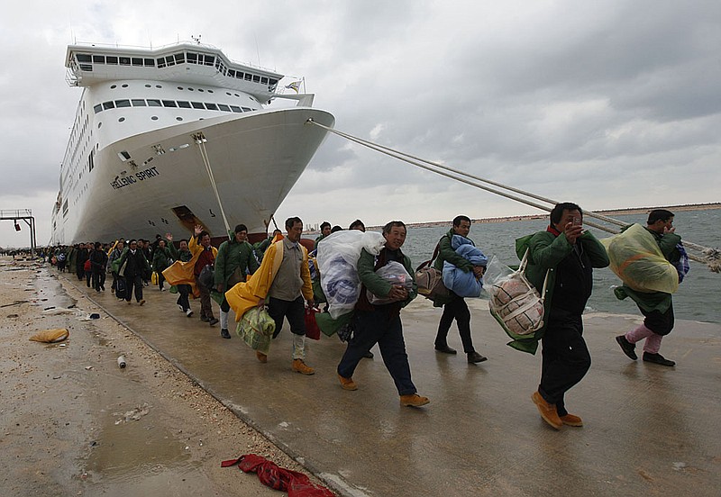 People from various nations head for ships Friday in Benghazi as they flee Libya’s unrest.

 