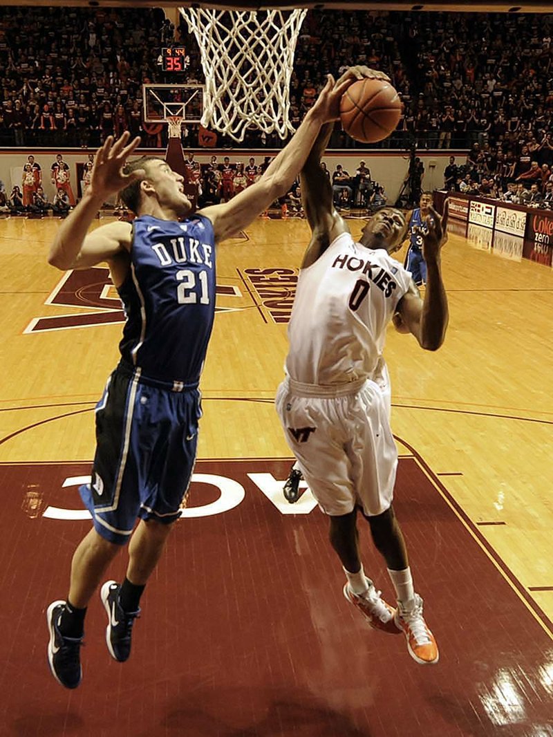 Virginia Tech’s Jeff Allen (right) and Duke’s Miles Plumlee (21) battle for a rebound during the first half of the Hokies’ 64-60 victory over the top-ranked Blue Devils on Saturday at Cassell Coliseum in Blacksburg, Va.

