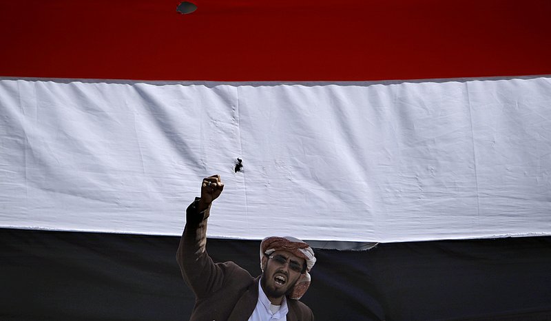 With the Yemen flag behind him Saturday, an anti-government protester in Sana shouts for the resignation of Yemen President Ali Abdullah Saleh.

 
