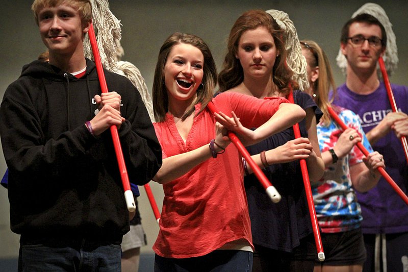 Summer Musical Intensive Theater performers (from left) George Elrod, Mary Katelin Ward, Taylor Quick and Tyler Rosenthal rehearse with mops for Review the Revue, opening Wednesday at the Arkansas Repertory Theatre. 