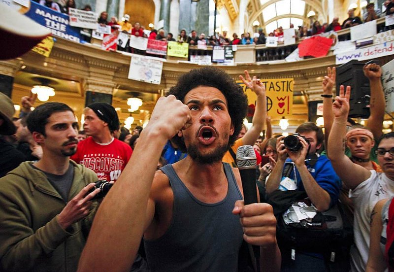 Damon Terrell talks to protesters at the state Capitol in Madison, Wis., on Sunday. 