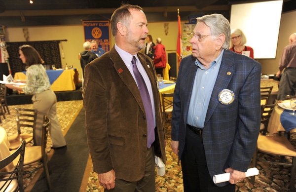 Kit Williams, left, Fayetteville city attorney, speaks Thursday with Lewis Epley following the a Rotary Club meeting at Savor in Fayetteville. Epley is working with other members of the club to raise $200,000 to help pay for global polio eradication efforts.
