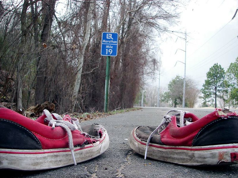A worn-out pair of shoes confronts Mile 19 of the Little Rock Marathon. This flat section of the 26.2-mile course is where runners are most likely to run out of energy and “hit the wall.” 