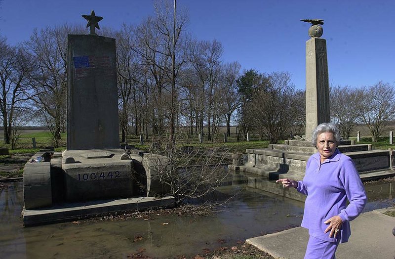 Rosalie Gould is pictured a decade ago with two memorials at Rohwer Relocation Center, where 8,500 Japanese-Americans were interned during World War II. Gould has given her nonpareil collection from the former camp in Desha County to the Butler Center for Arkansas Studies. 
