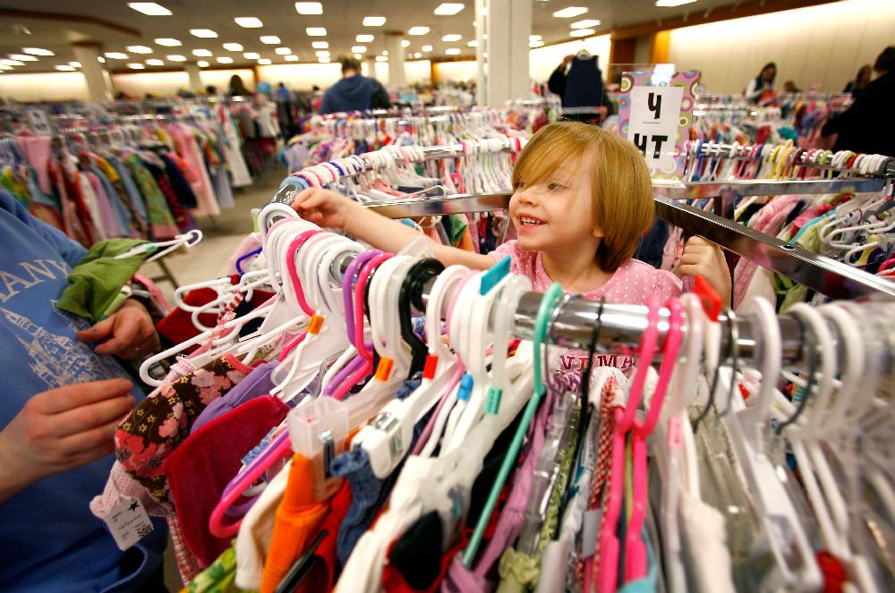 Arkansas Democrat-Gazette/JASON IVESTER --03/08/11--
Elizabeth Salsbury (cq), 3, helps her mother, Jennifer Salsbury, both of Rogers, pick out clothing on Tuesday, March 8, 2011, during the Rhea Lana's Spring Children's Consignment Event inside the Frisco Station Mall in Rogers. The event which has 67,000 items provided by 725 Northwest Arkansas families continues through Saturday.