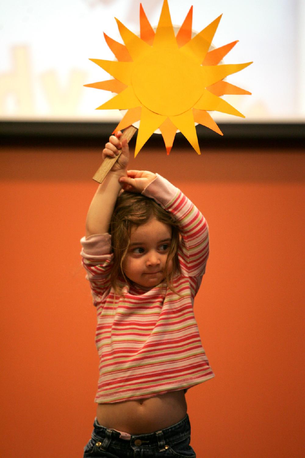 Arkansas Democrat-Gazette/RYAN MCGEENEY 
--03-08-2011--
Blue Berenguel, 3, plays the part of sunshine in a sing-a-long play about the spring season Tuesday at the Fayetteville Public Library during pre-school story time. The half-hour story-reading gathering is held at 10:30 each Monday, Tuesday and Wednesday morning.