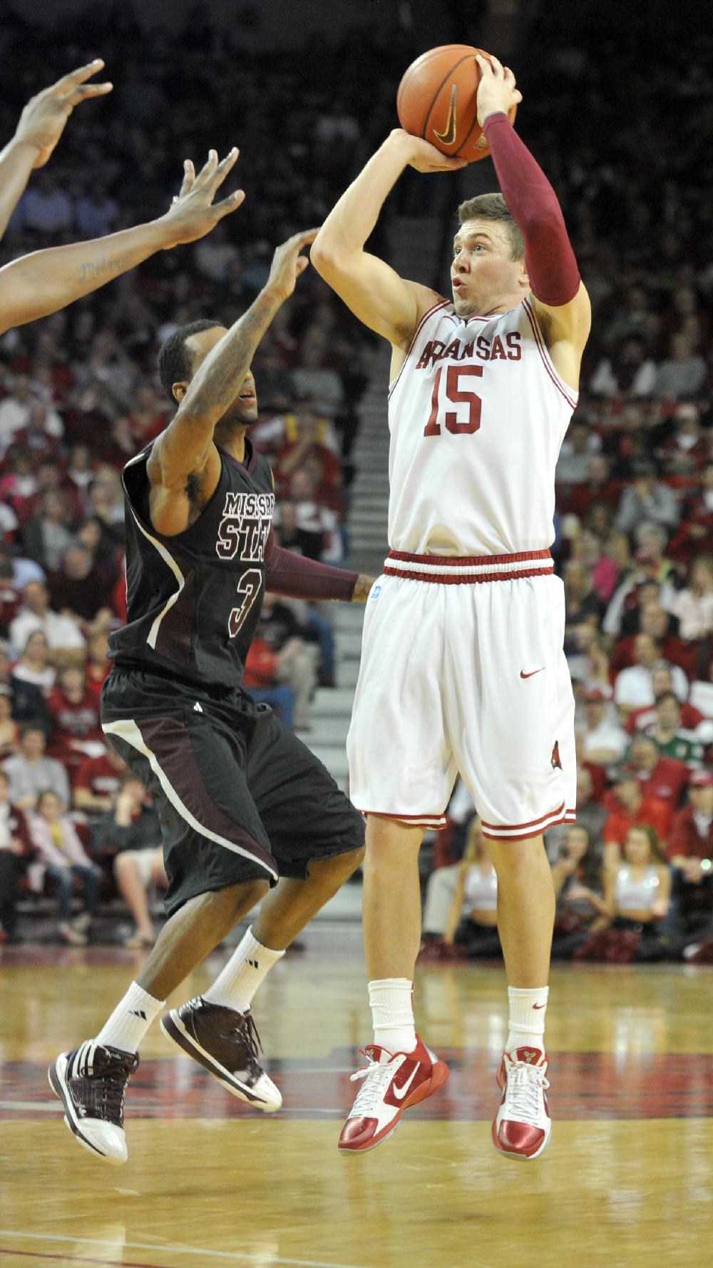 Arkansas Democrat-Gazette/MICHAEL WOODS --03/01/11-- University of Arkansas guard Rotnei Clarke pulls up for a three point shot over Mississippi State defender Dee Bost in the second half of Wednesday nights game at Bud Walton Arena in Fayetteville.