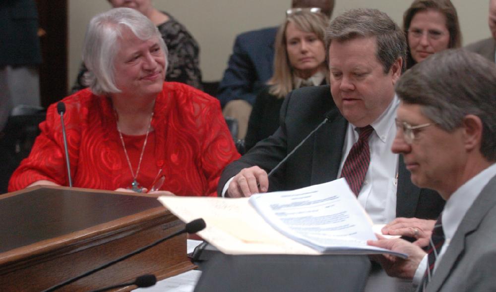 Arkansas Democrat-Gazette/STEVE KEESEE 3/8/11 State Rep, Theresia Pennartz (left), D-Fort Smith, listens as Tim Leathers (center), and John Theis, both with the state's Department of Finance and Administration speak Tuesday against her bill, HB1118, the investment tax credit for business improvement districts, in the House Committee on Revenue and Taxation.